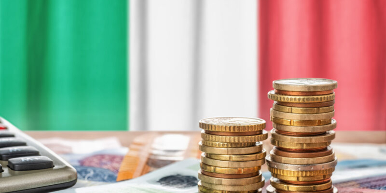 Euro banknotes and coins in front of the national flag of Italy